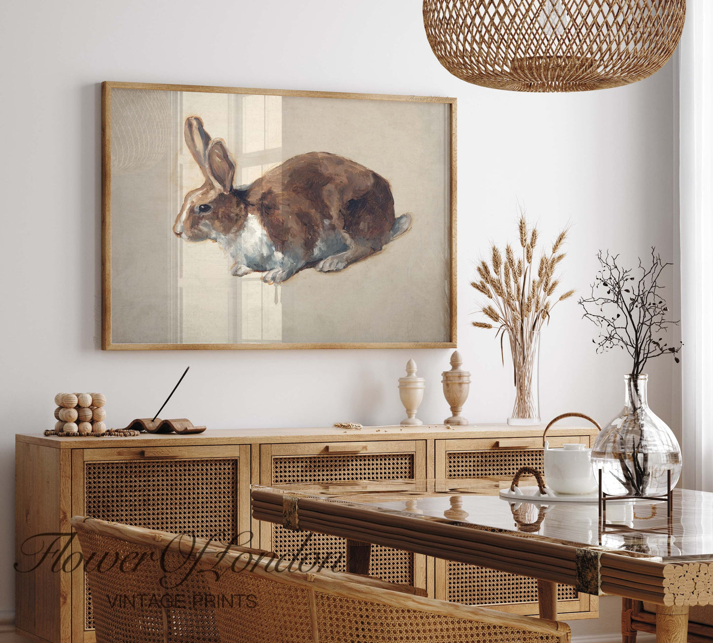 a painting of a rabbit hangs above a dining room table