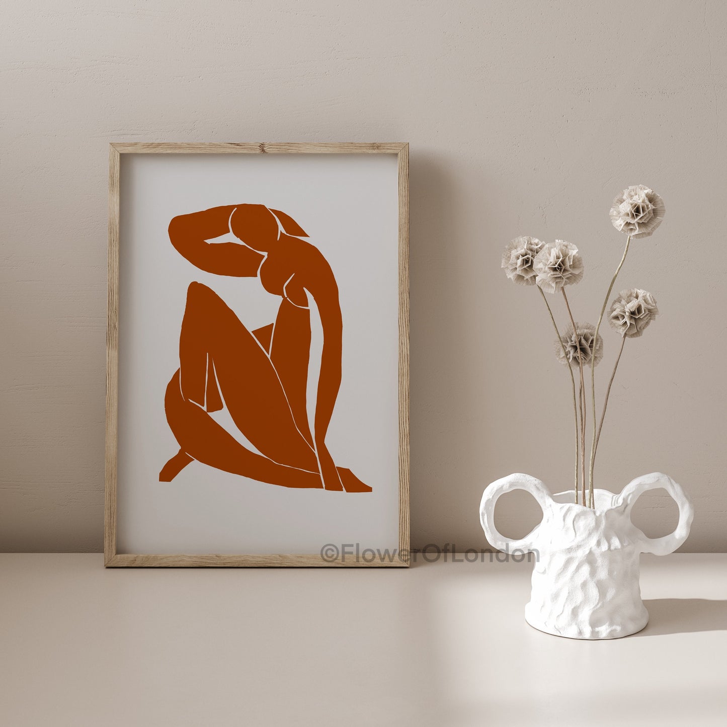 Bold Matisse nude figure poster styled in a contemporary bedroom above the bed