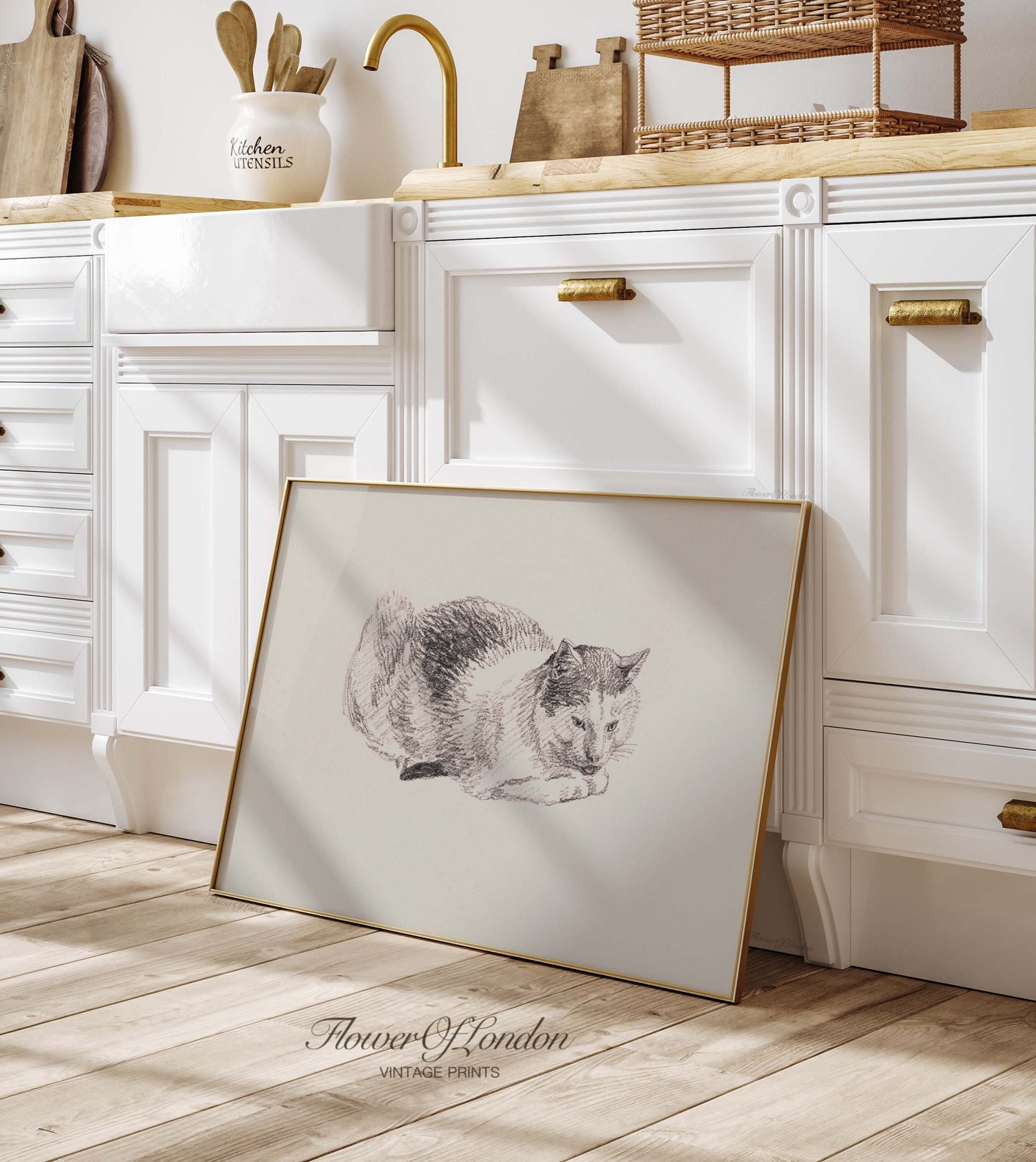 a framed picture of a cat sitting on a kitchen floor