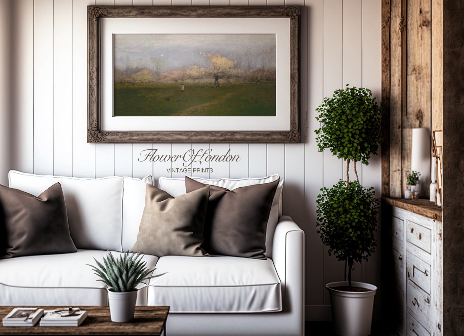 a living room with a white couch and a painting on the wall