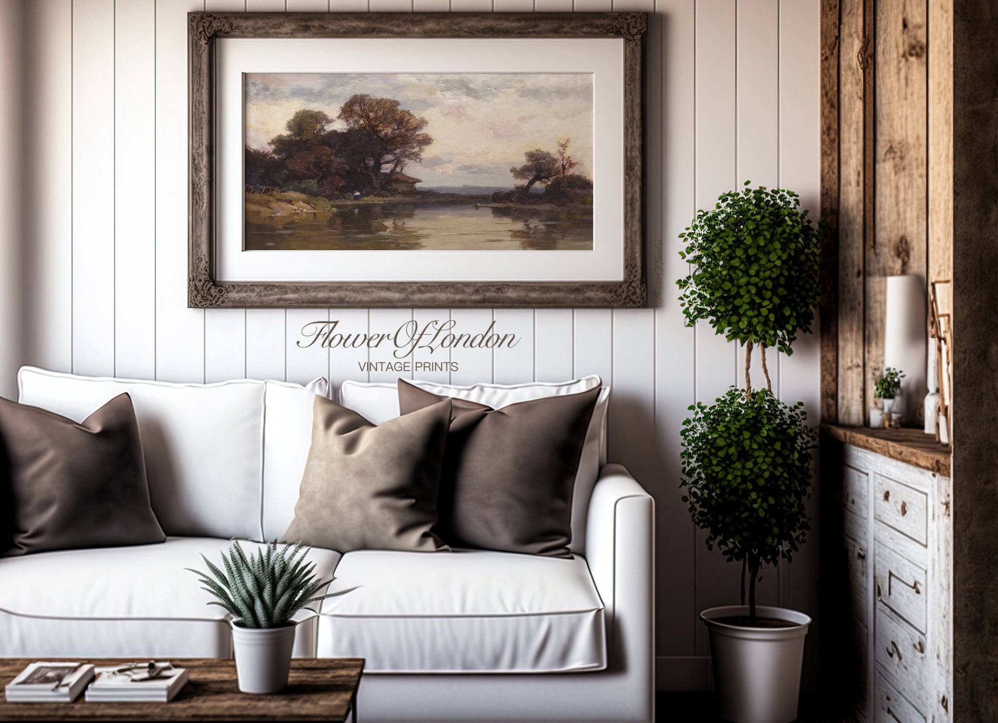 a living room with a white couch and a painting on the wall